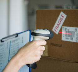 Closeup,shot,of,worker,scanning,box,with,barcode,reader.,reading